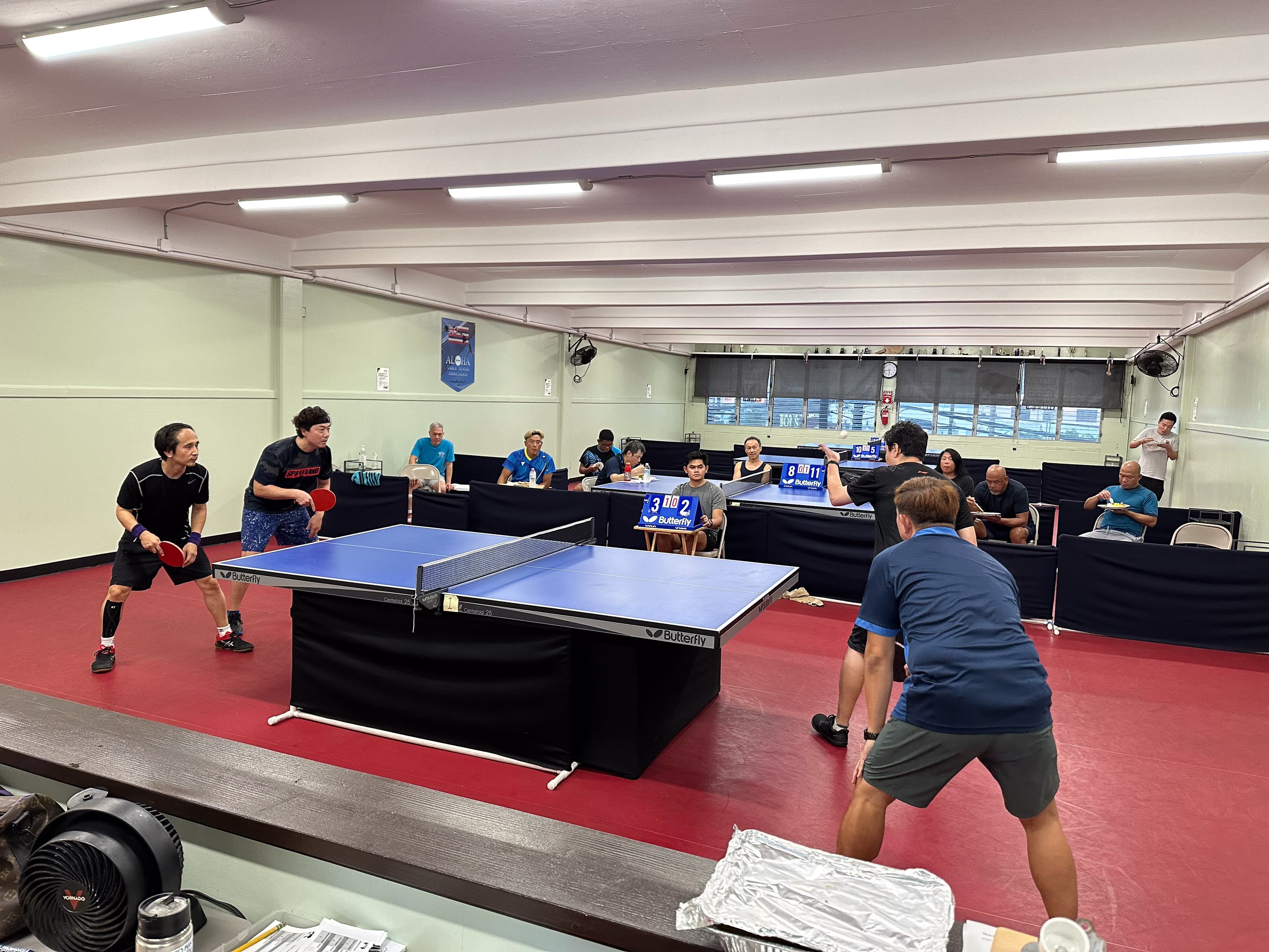 Players competing in a table tennis match at ATTA in Honolulu
